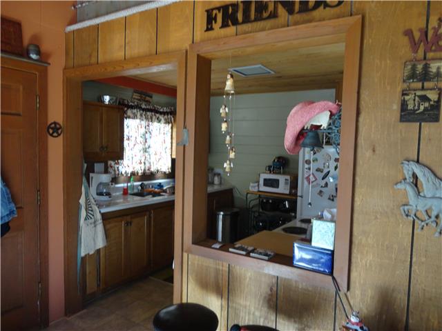 739 Aaron Webb Road Smithville, TN 37166 - Photo 5 of 15 Pass thru window from kitchen to living room opens up the space.