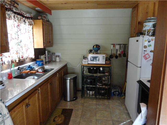 739 Aaron Webb Road Smithville, TN 37166 - Photo 6 of 15 Kitchen galley with stove and refrigerator.