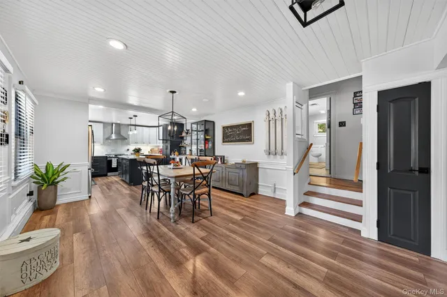 a view of a dining room with furniture and a chandelier