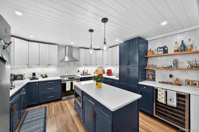 a kitchen with a refrigerator a sink dishwasher and a stove with wooden floor