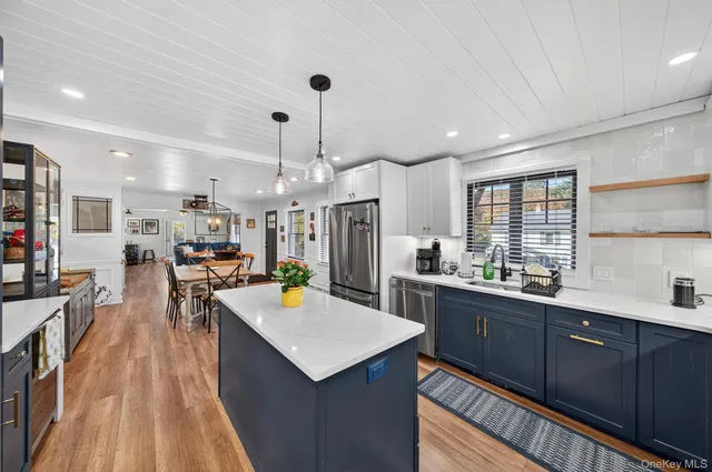 a kitchen with lots of counter top space and wooden floor