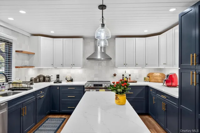 a kitchen with stainless steel appliances granite countertop a sink stove and cabinets