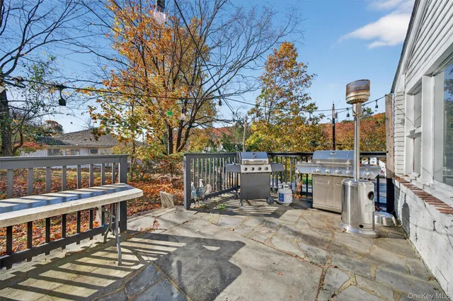 a backyard of a house with barbeque oven and outdoor seating