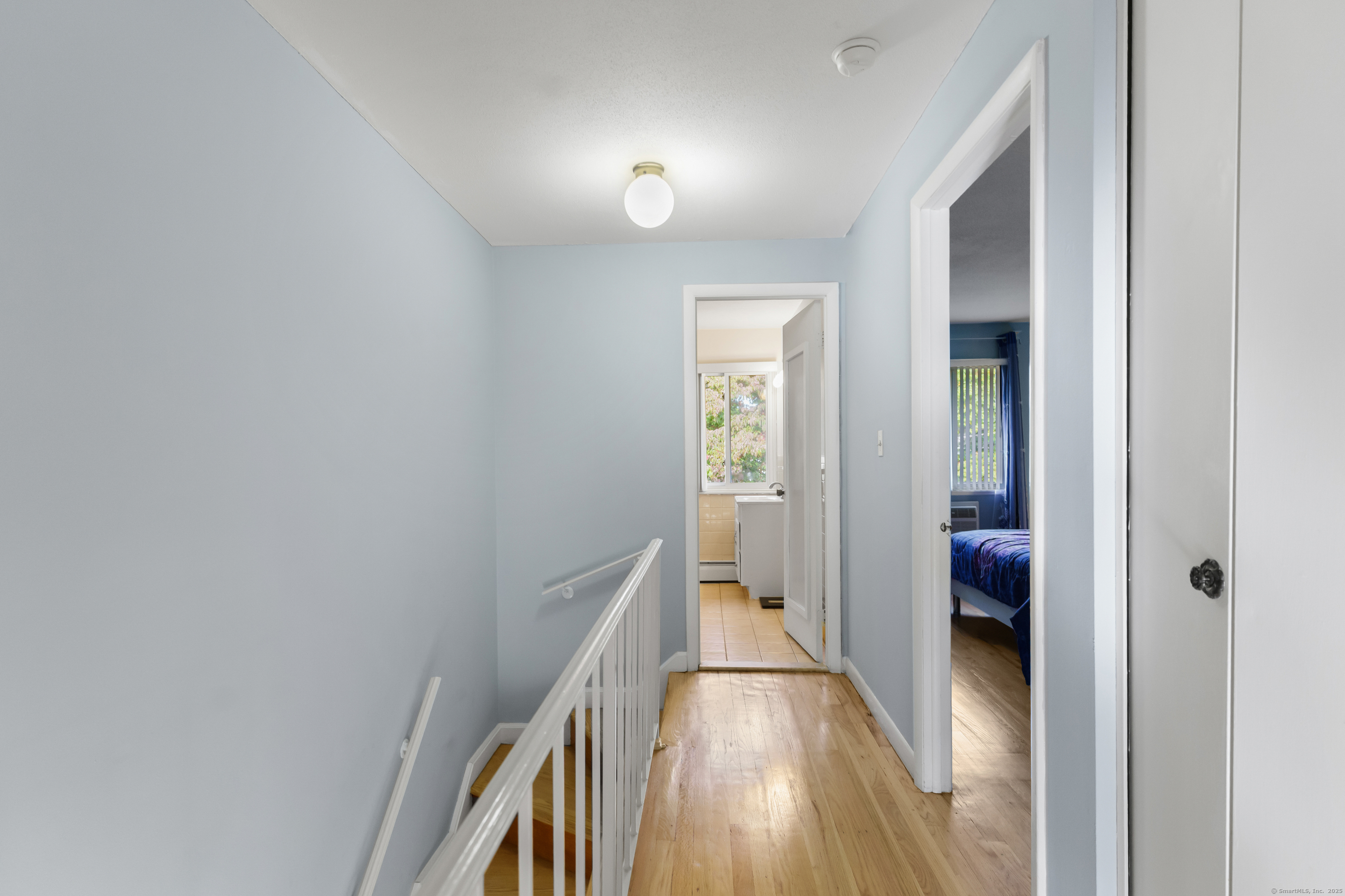 248 Centerbrook Road Hamden, CT 06518 - Photo 11 of 30 a view of a hallway with wooden floor and staircase
