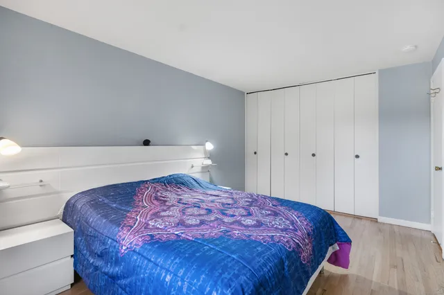 a bedroom with a bed and a night stand