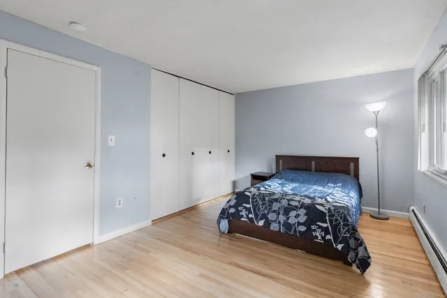 a bed sitting in a bedroom next to a window