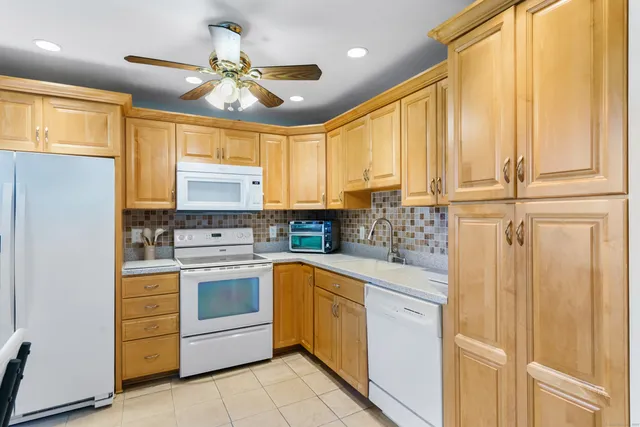 a kitchen with a white cabinets and white appliances