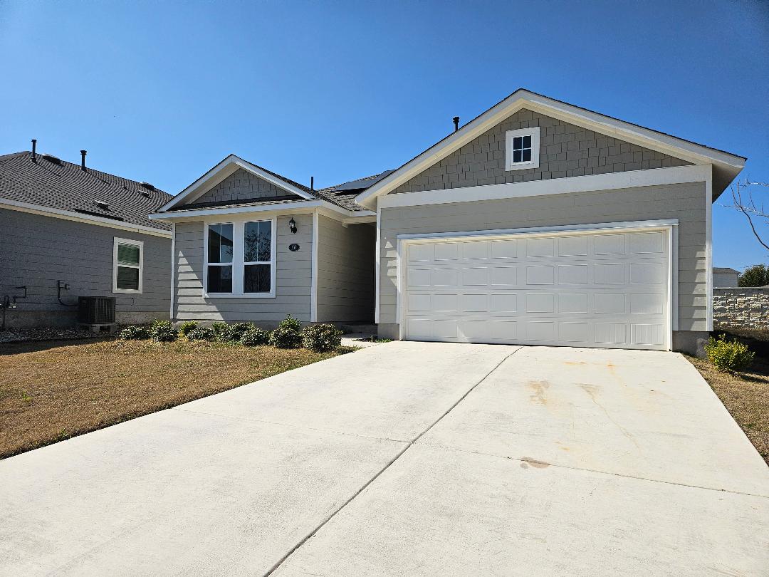 162 Hayloft Lane Elgin, TX 78621 - Photo 1 of 26 a front view of a house with a yard and garage