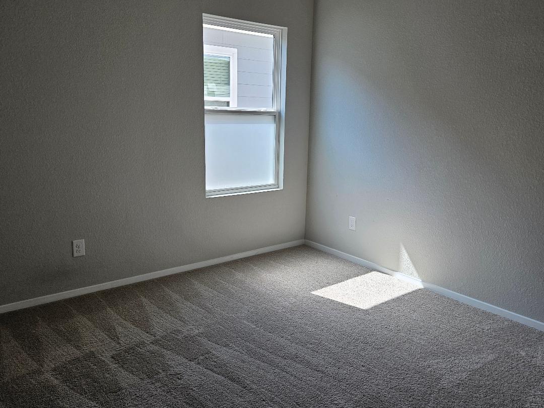 162 Hayloft Lane Elgin, TX 78621 - Photo 13 of 26 an empty room with a empty space and window