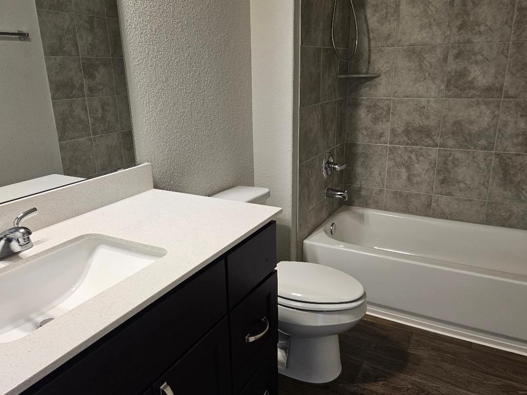 162 Hayloft Lane Elgin, TX 78621 - Photo 14 of 26 a bathroom with a sink toilet vanity and bathtub