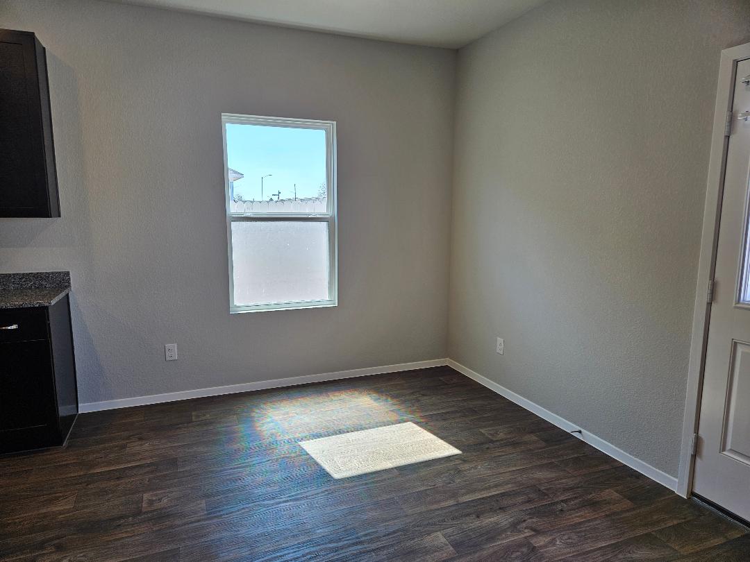 162 Hayloft Lane Elgin, TX 78621 - Photo 5 of 26 an empty room with wooden floor and windows