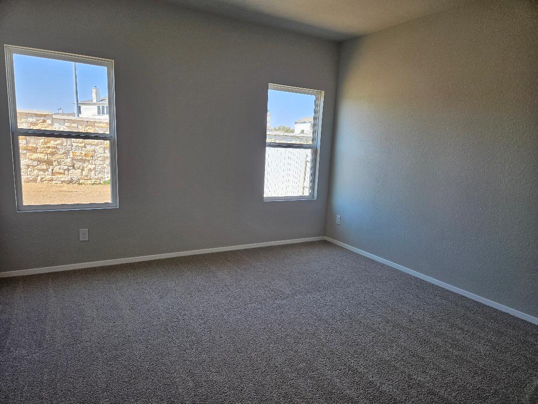 162 Hayloft Lane Elgin, TX 78621 - Photo 7 of 26 an empty room with a window