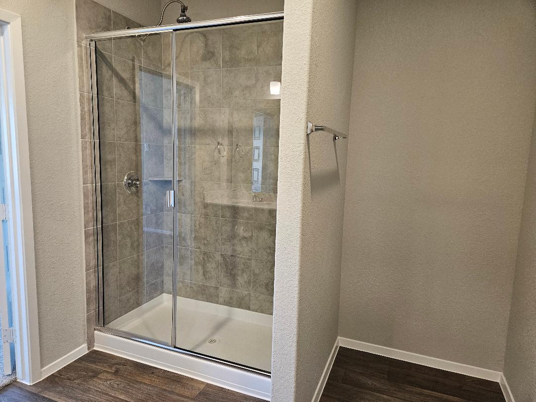 162 Hayloft Lane Elgin, TX 78621 - Photo 9 of 26 a bathroom with a glass shower door