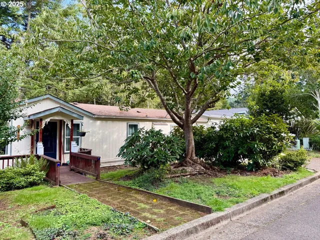 a front view of a house with a garden