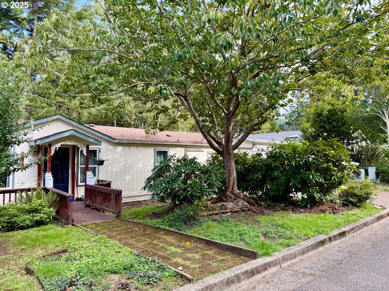a front view of a house with a garden