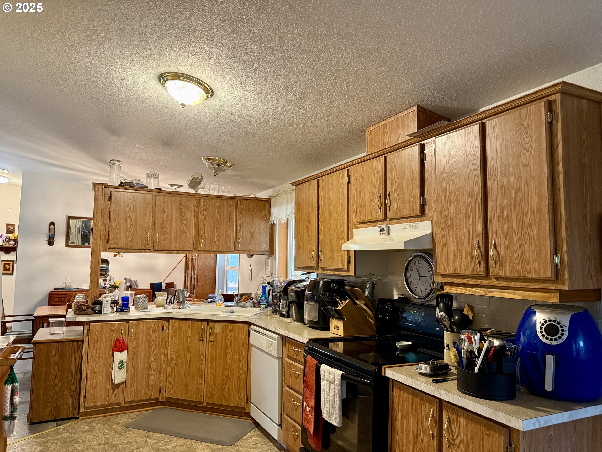 1305 Kristi Loop Lakeside, OR 97449 - Photo 12 of 25 a kitchen with granite countertop a stove top oven sink and cabinets