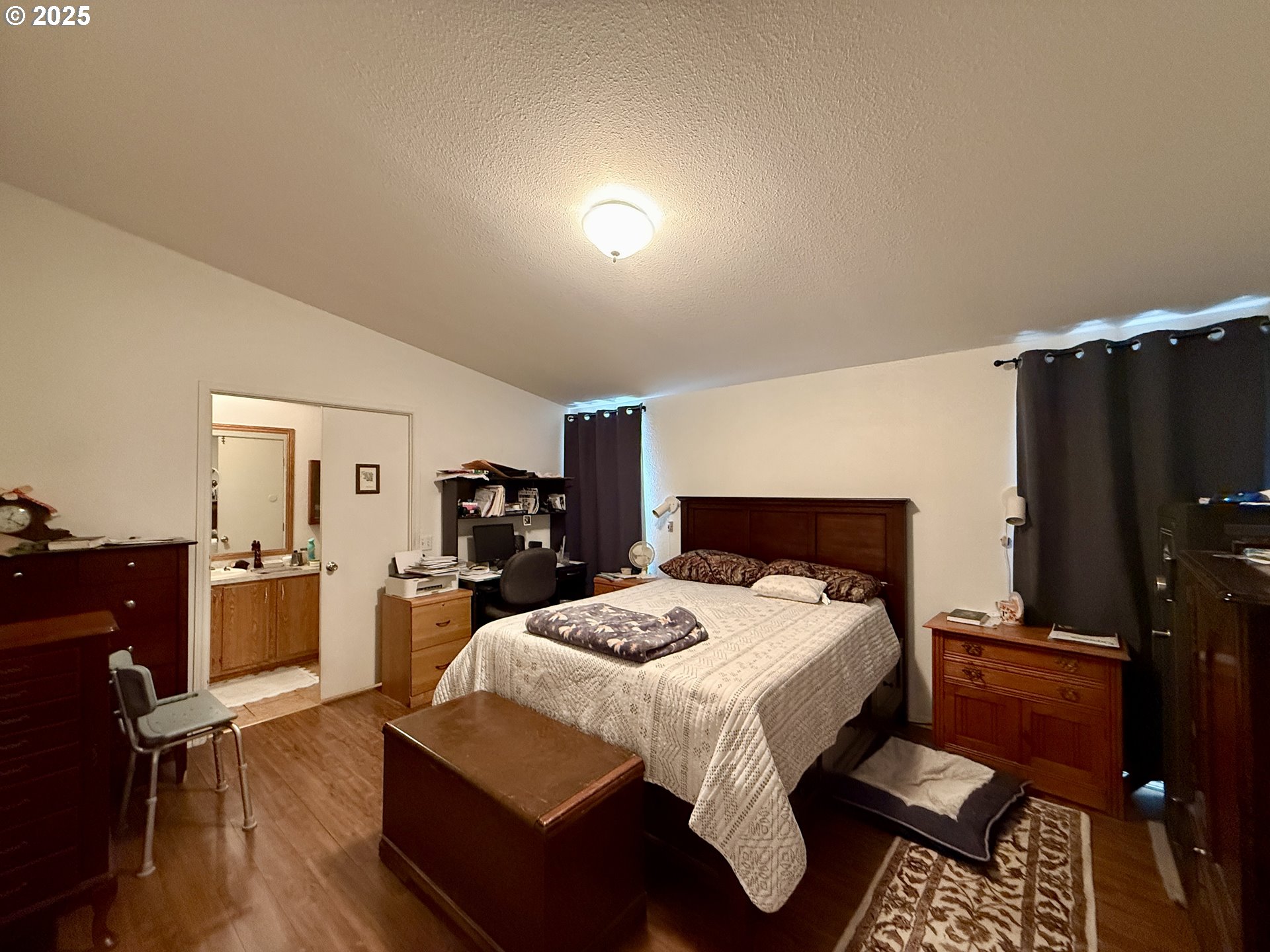 1305 Kristi Loop Lakeside, OR 97449 - Photo 18 of 25 a bedroom with a bed and wooden floor