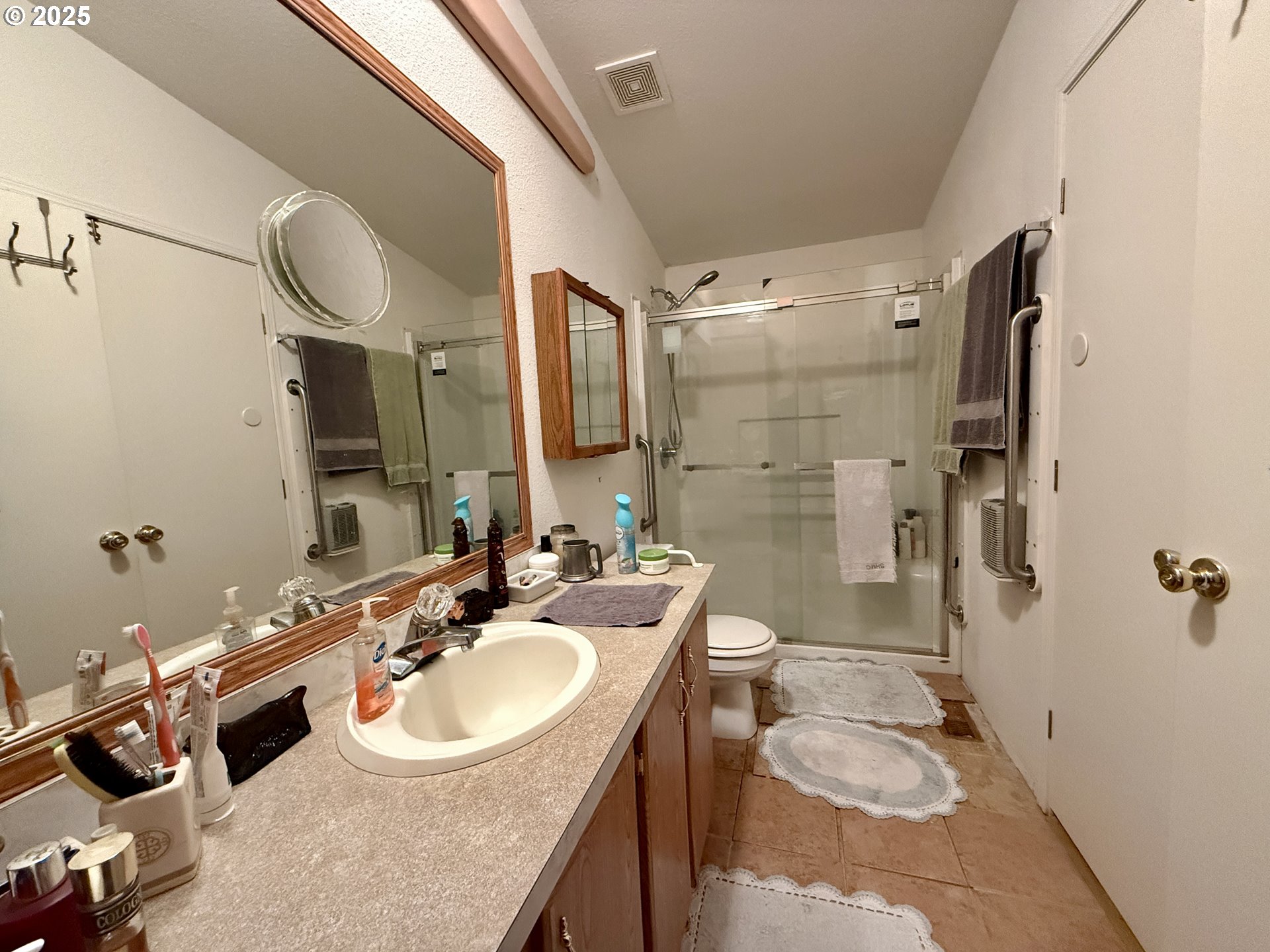 1305 Kristi Loop Lakeside, OR 97449 - Photo 19 of 25 a bathroom with a sink double vanity and a mirror