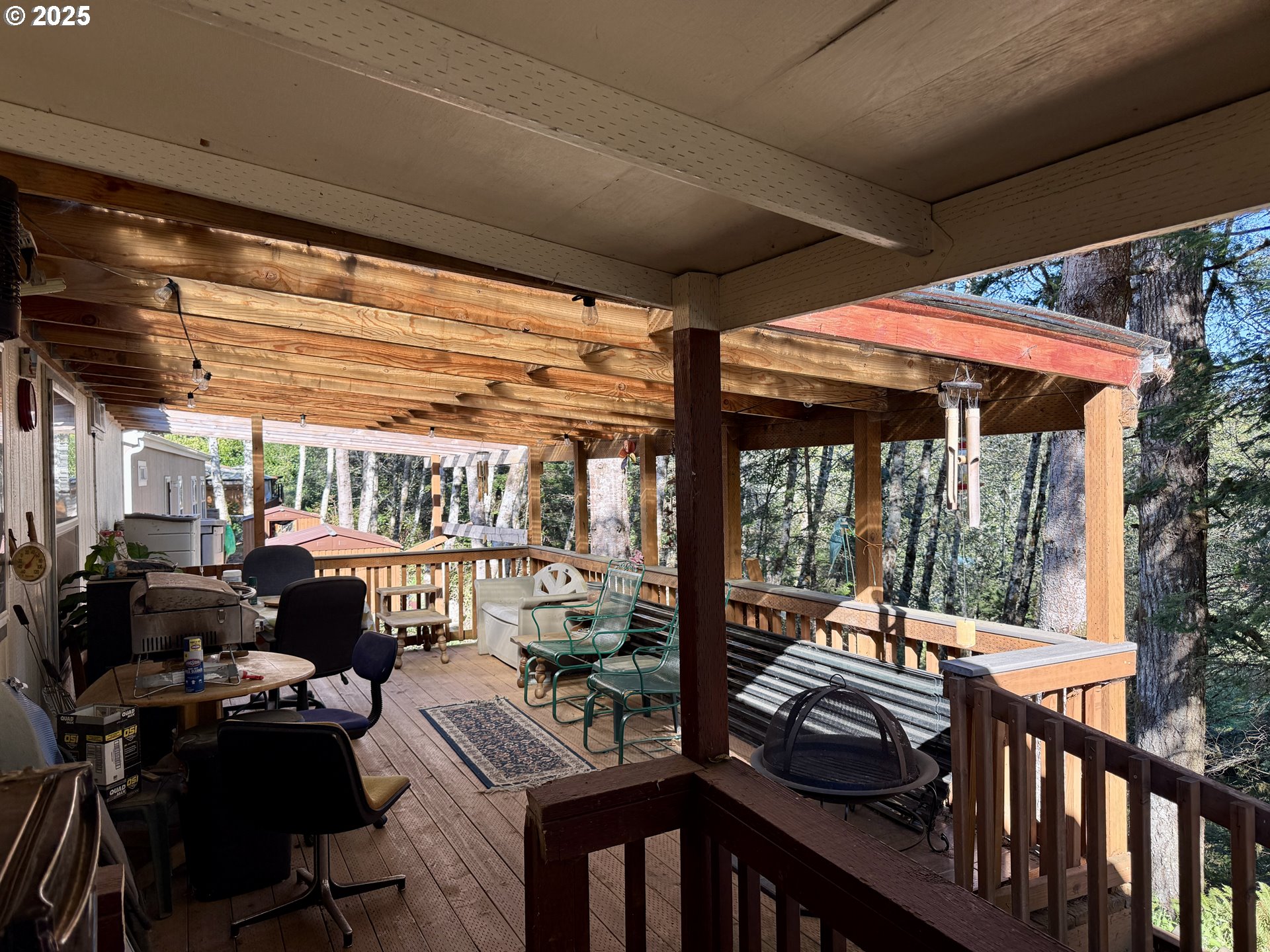 1305 Kristi Loop Lakeside, OR 97449 - Photo 23 of 25 a view of a patio with a dining table and chairs