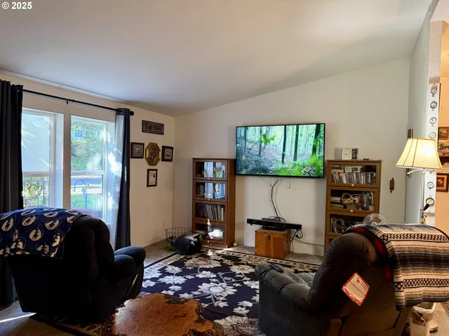 a living room with furniture and a floor to ceiling window
