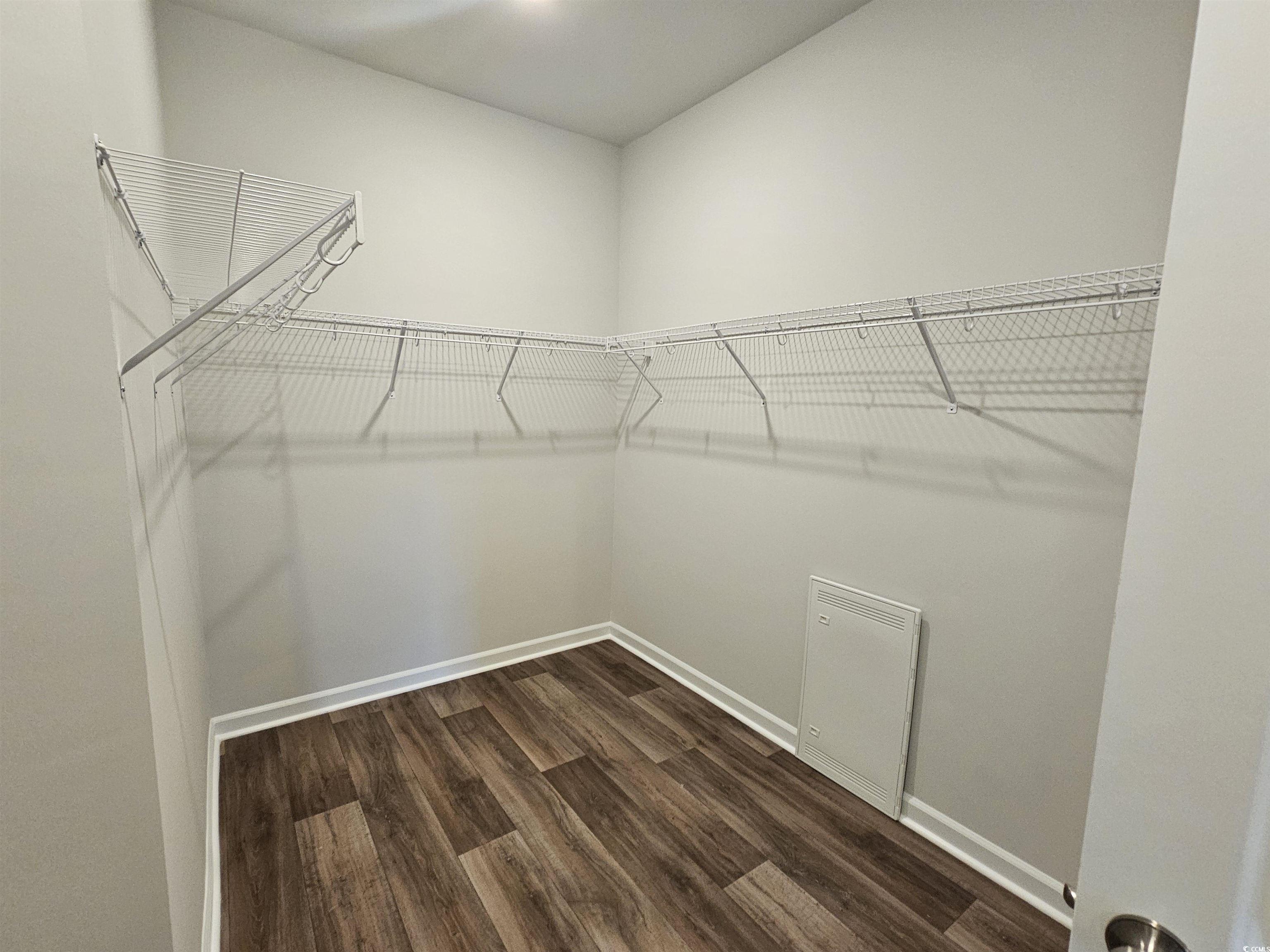 800 Wapama Street Little River, SC 29566 - Photo 13 of 34 Walk in closet featuring dark wood-style floors