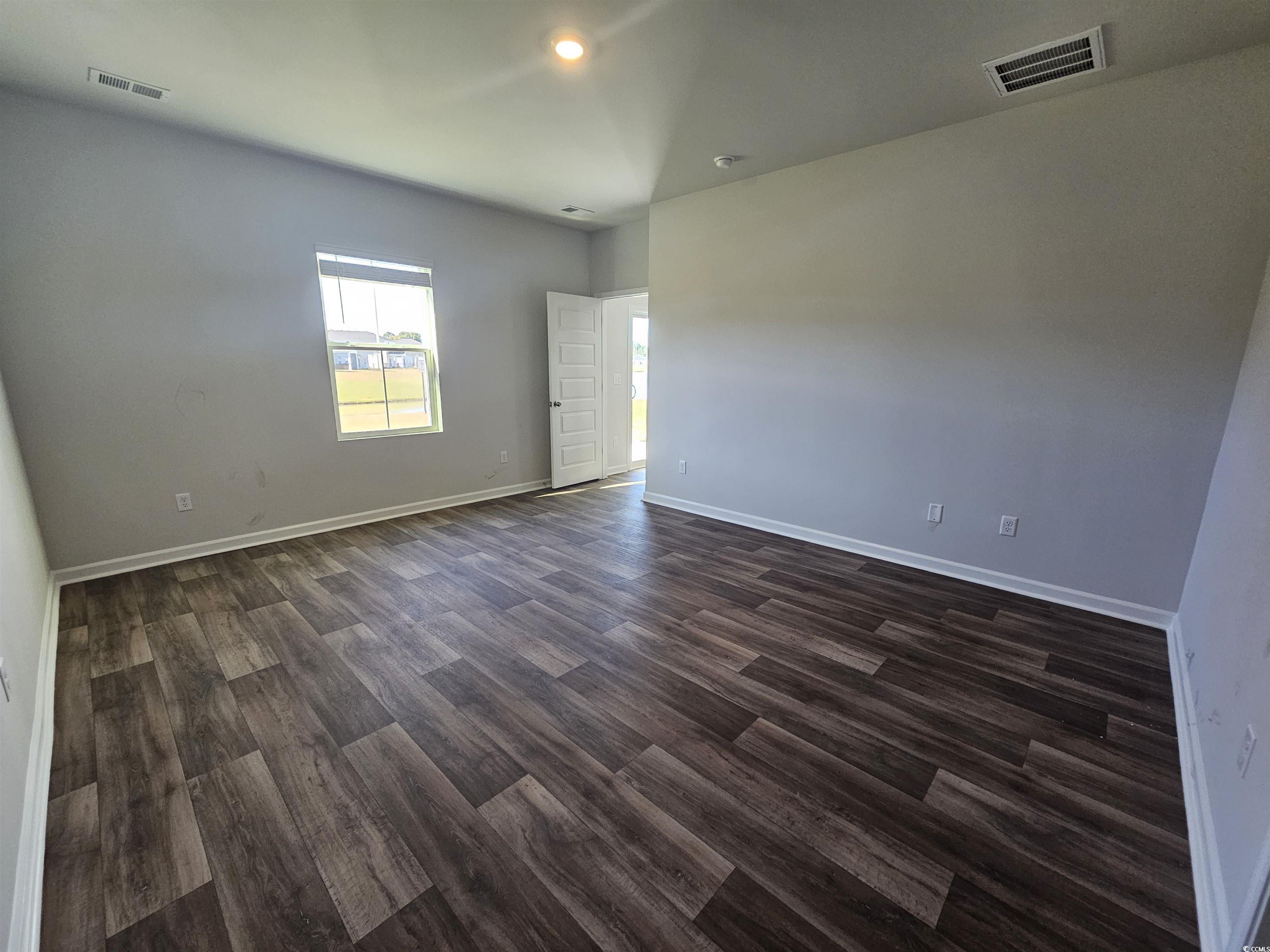 800 Wapama Street Little River, SC 29566 - Photo 16 of 34 Empty room featuring dark wood-style floors and recessed lighting
