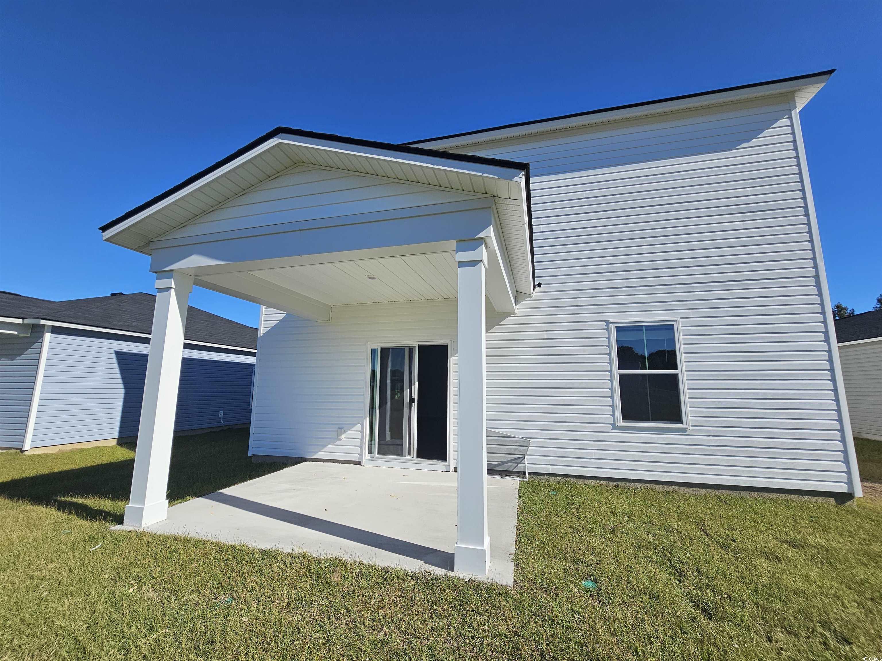 800 Wapama Street Little River, SC 29566 - Photo 2 of 34 Rear view of property featuring a lawn and a patio area