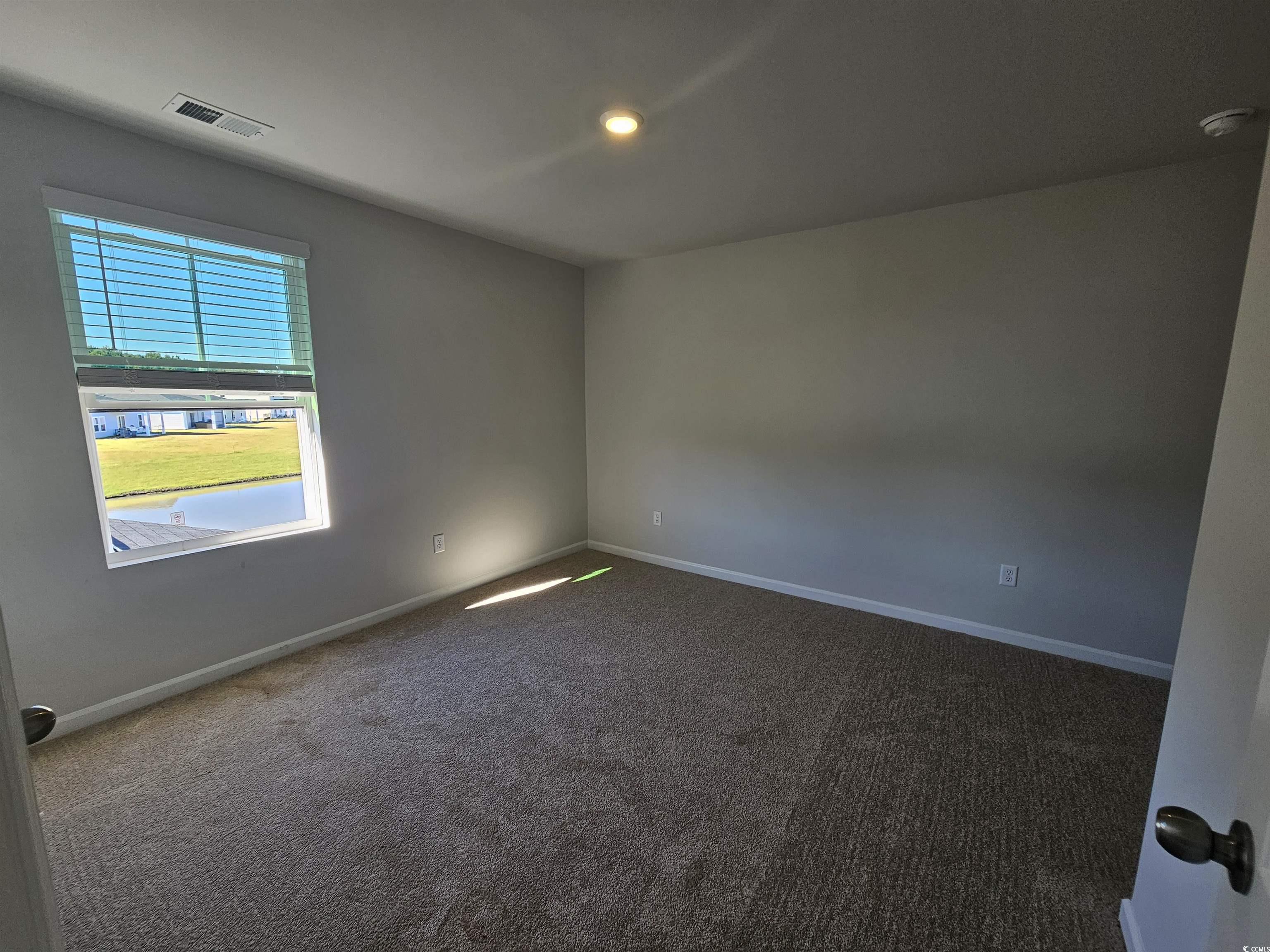 800 Wapama Street Little River, SC 29566 - Photo 25 of 34 Empty room with dark carpet and recessed lighting
