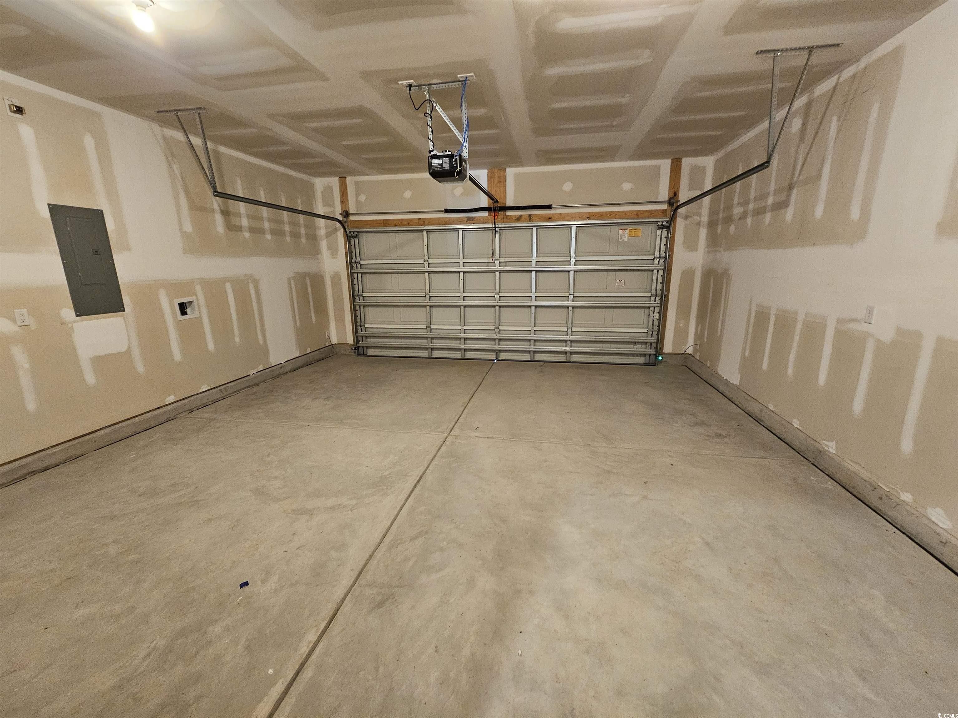 800 Wapama Street Little River, SC 29566 - Photo 28 of 34 Garage with electric panel and a garage door opener