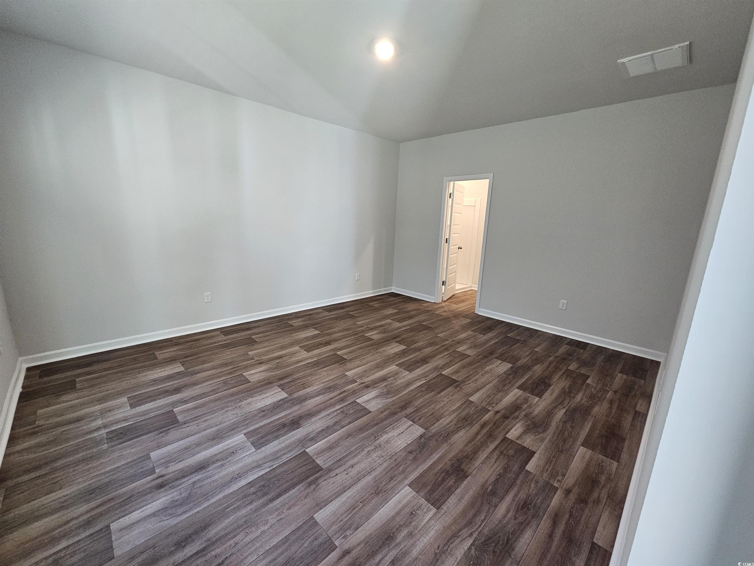 800 Wapama Street Little River, SC 29566 - Photo 29 of 34 Unfurnished room featuring dark wood-style floors and baseboards