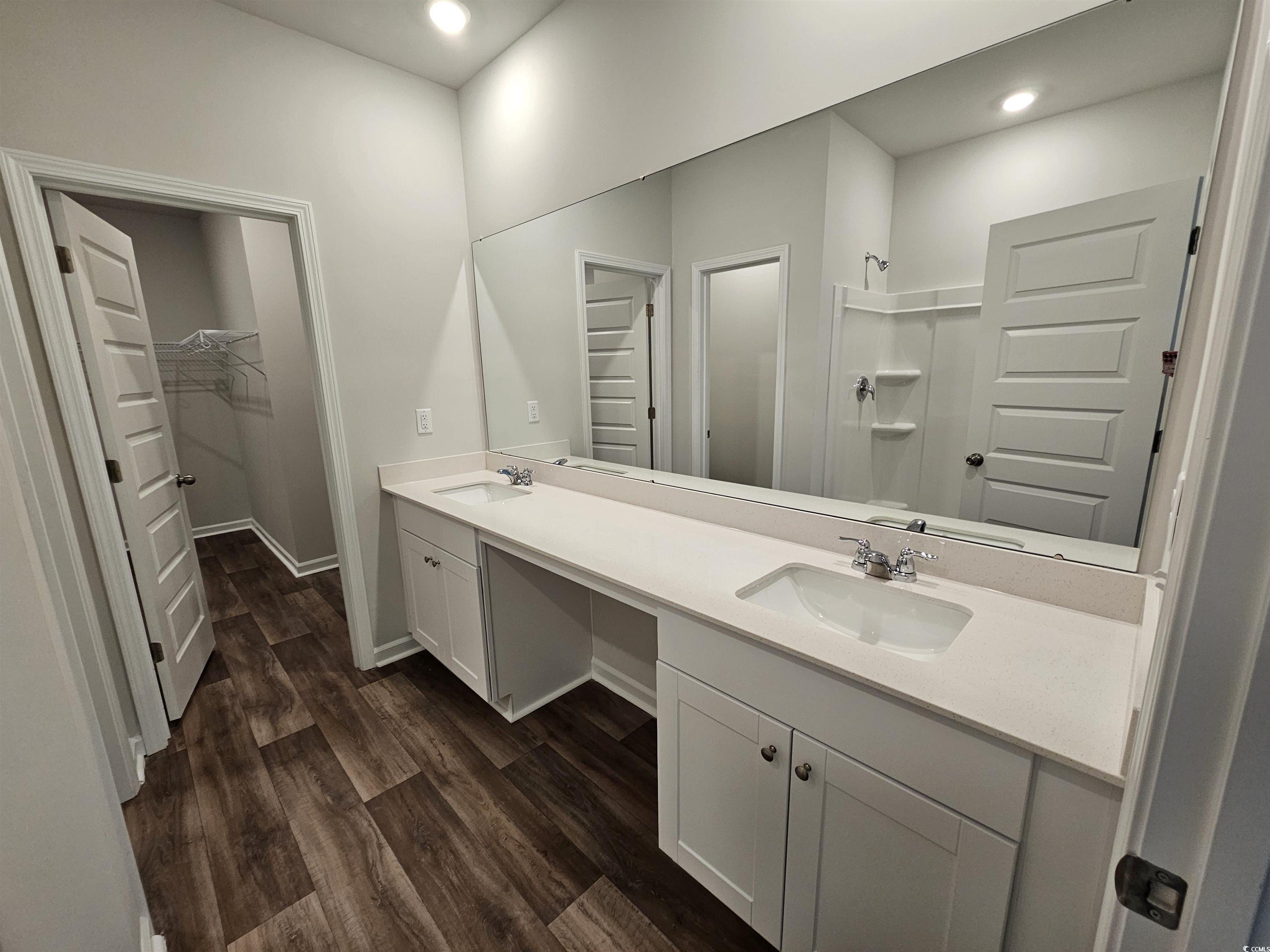 800 Wapama Street Little River, SC 29566 - Photo 30 of 34 Full bath with a spacious closet, double vanity, recessed lighting, dark wood-type flooring, and a shower