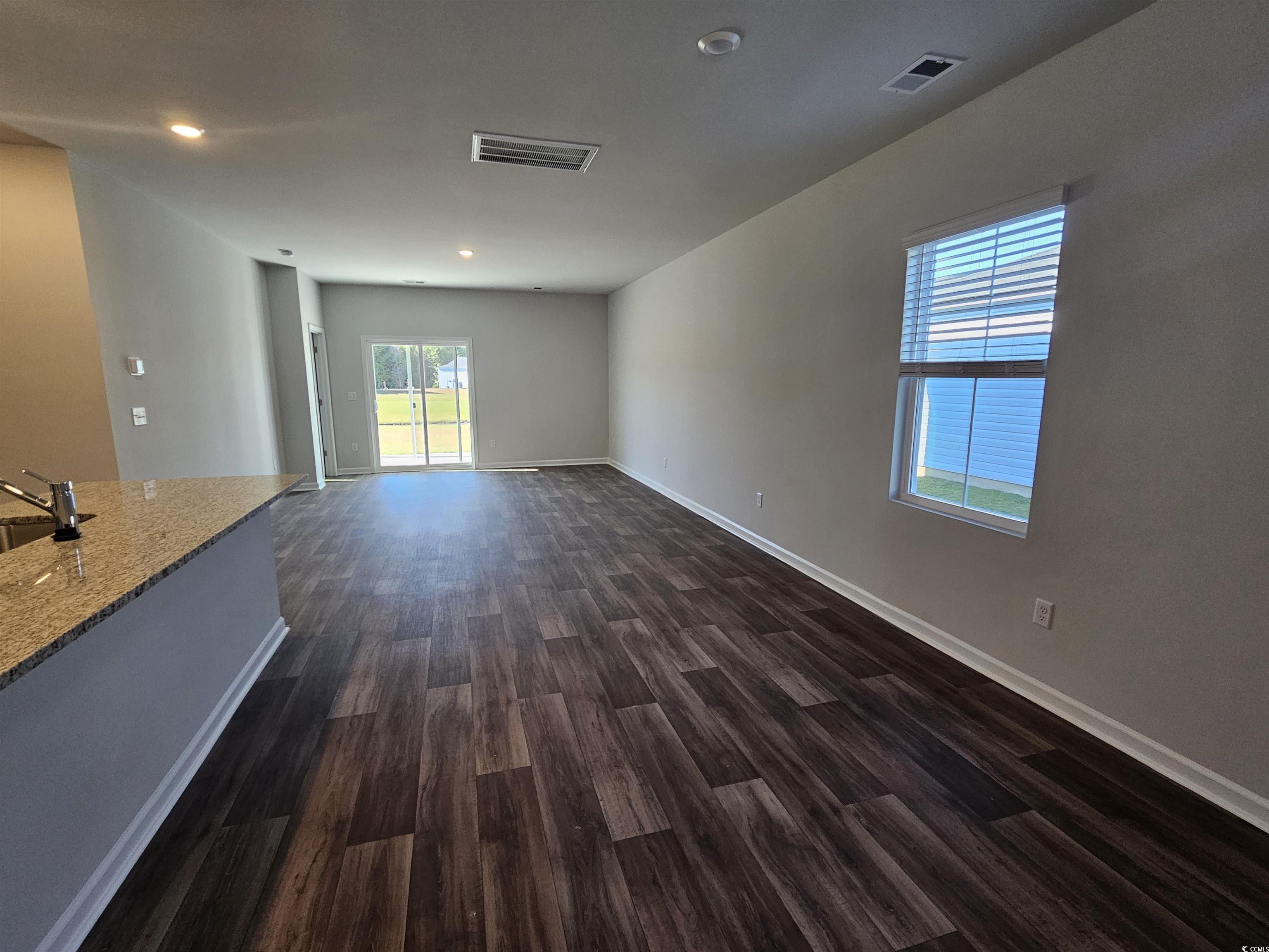 800 Wapama Street Little River, SC 29566 - Photo 9 of 34 Unfurnished living room with dark wood-style floors and recessed lighting