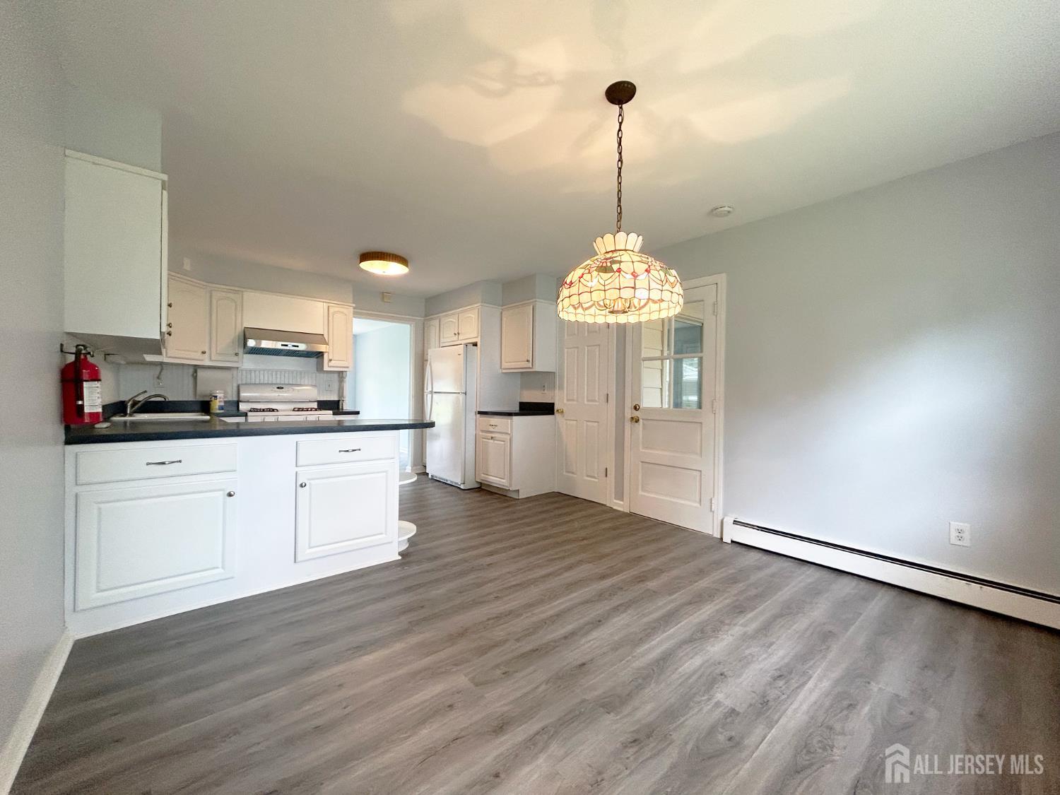 3 Stiles Road Edison, NJ 08817 - Photo 11 of 21 a kitchen with stainless steel appliances granite countertop a sink dishwasher a refrigerator white cabinets and wooden floor