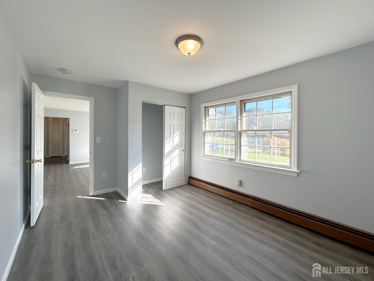 3 Stiles Road Edison, NJ 08817 - Photo 15 of 21 a view of an empty room with wooden floor and a window