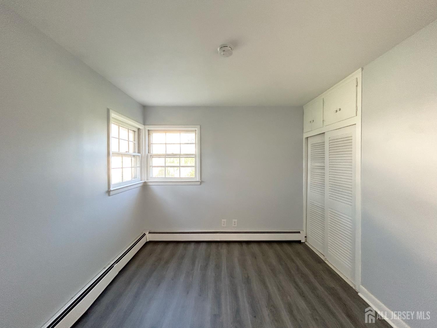 3 Stiles Road Edison, NJ 08817 - Photo 16 of 21 an empty room with wooden floor and windows