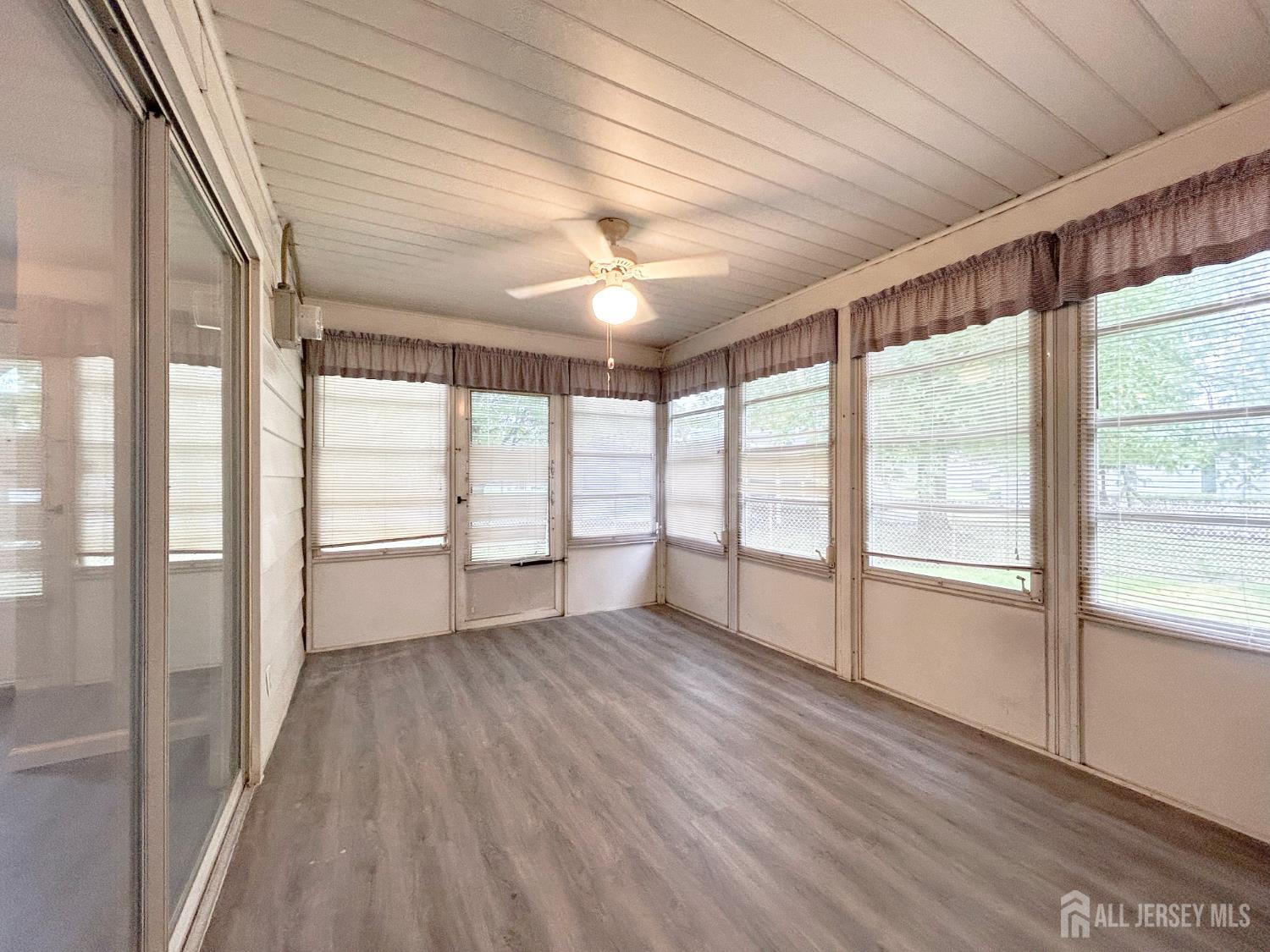 3 Stiles Road Edison, NJ 08817 - Photo 20 of 21 a view of an empty room with a window and wooden floor