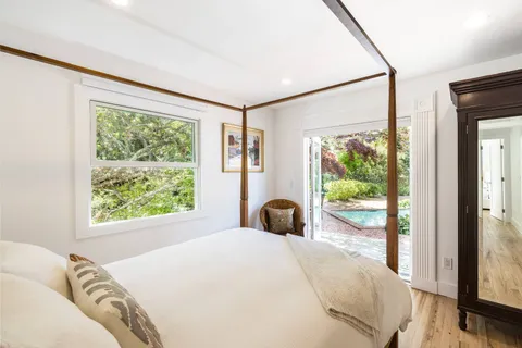 a bedroom with a large bed and a large window