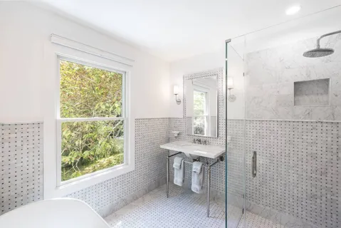 a bathroom with a granite countertop sink toilet and shower