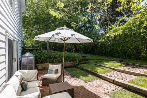a view of backyard with furniture and garden
