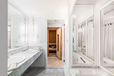 a bathroom with a tub shower and sink