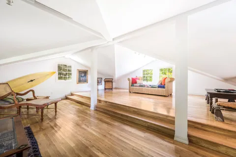 a hallway with wooden floor and furniture