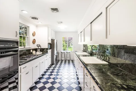 a kitchen with sink stove and cabinets