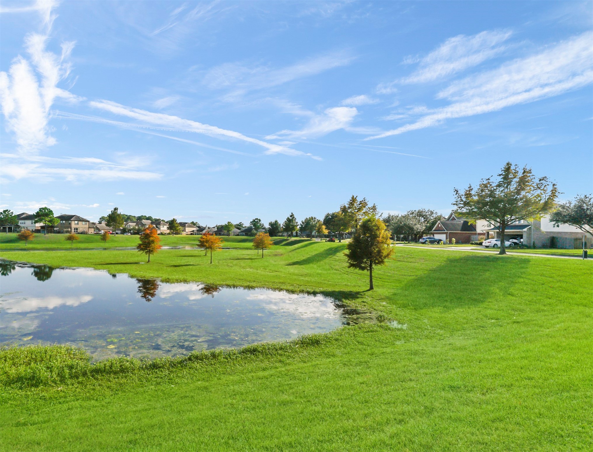 8214 Garrison Point Drive Houston, TX 77040 - Photo 35 of 37 a view of a golf course with a lake