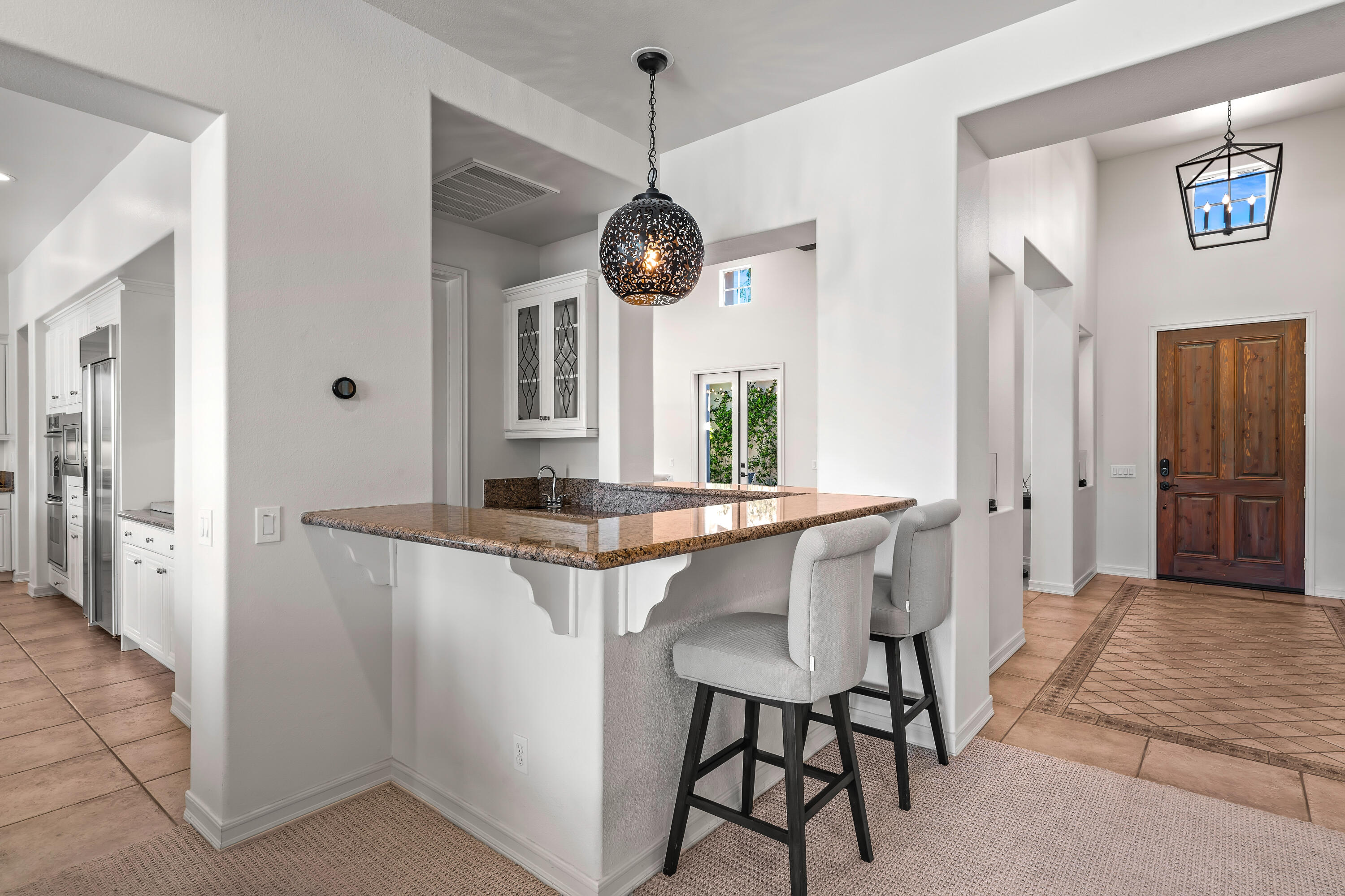362 Loch Lomond Road Rancho Mirage, CA 92270 - Photo 16 of 26 a dining room with granite countertop furniture and a large window