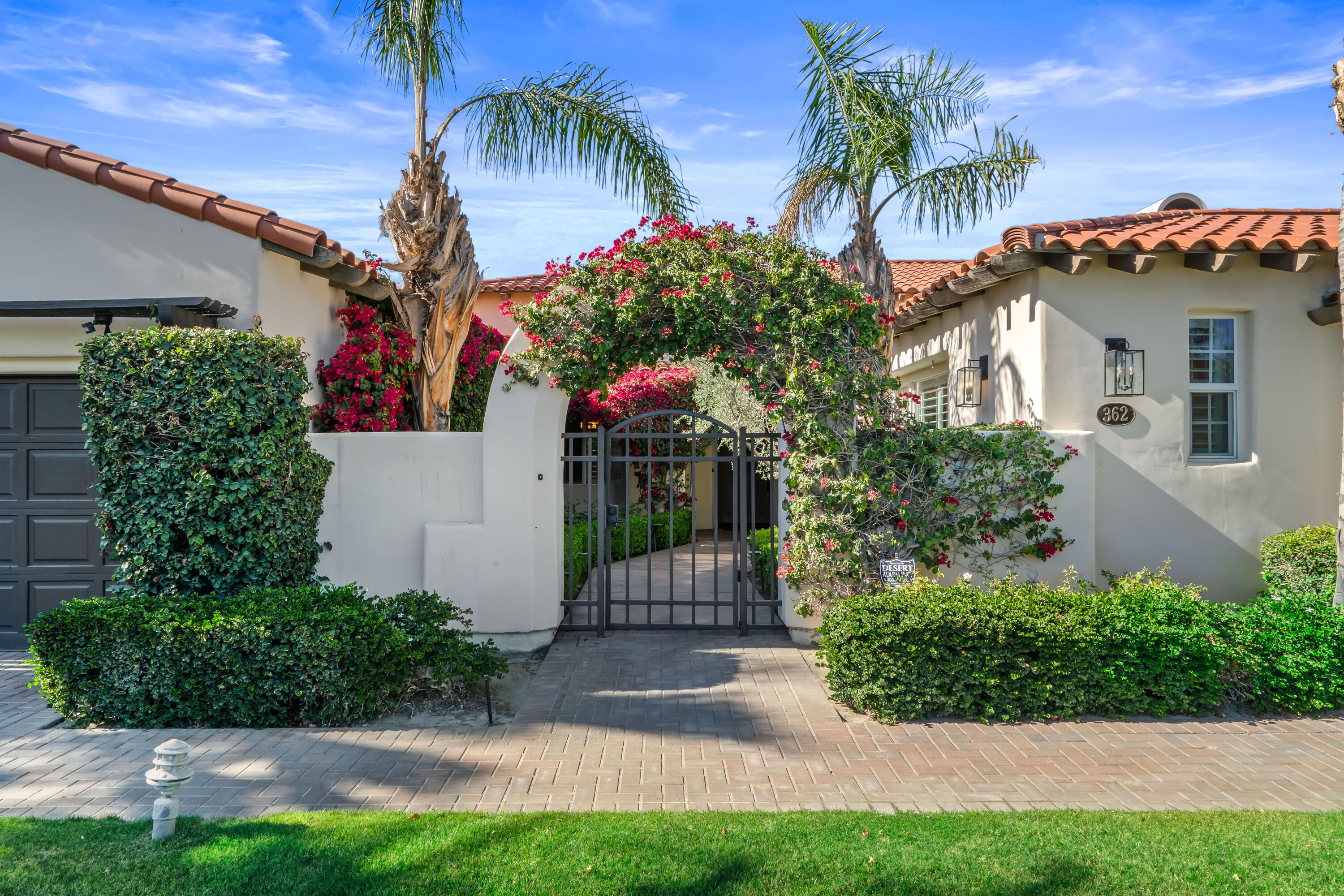 362 Loch Lomond Road Rancho Mirage, CA 92270 - Photo 8 of 26 a front view of a house with a yard and potted plants