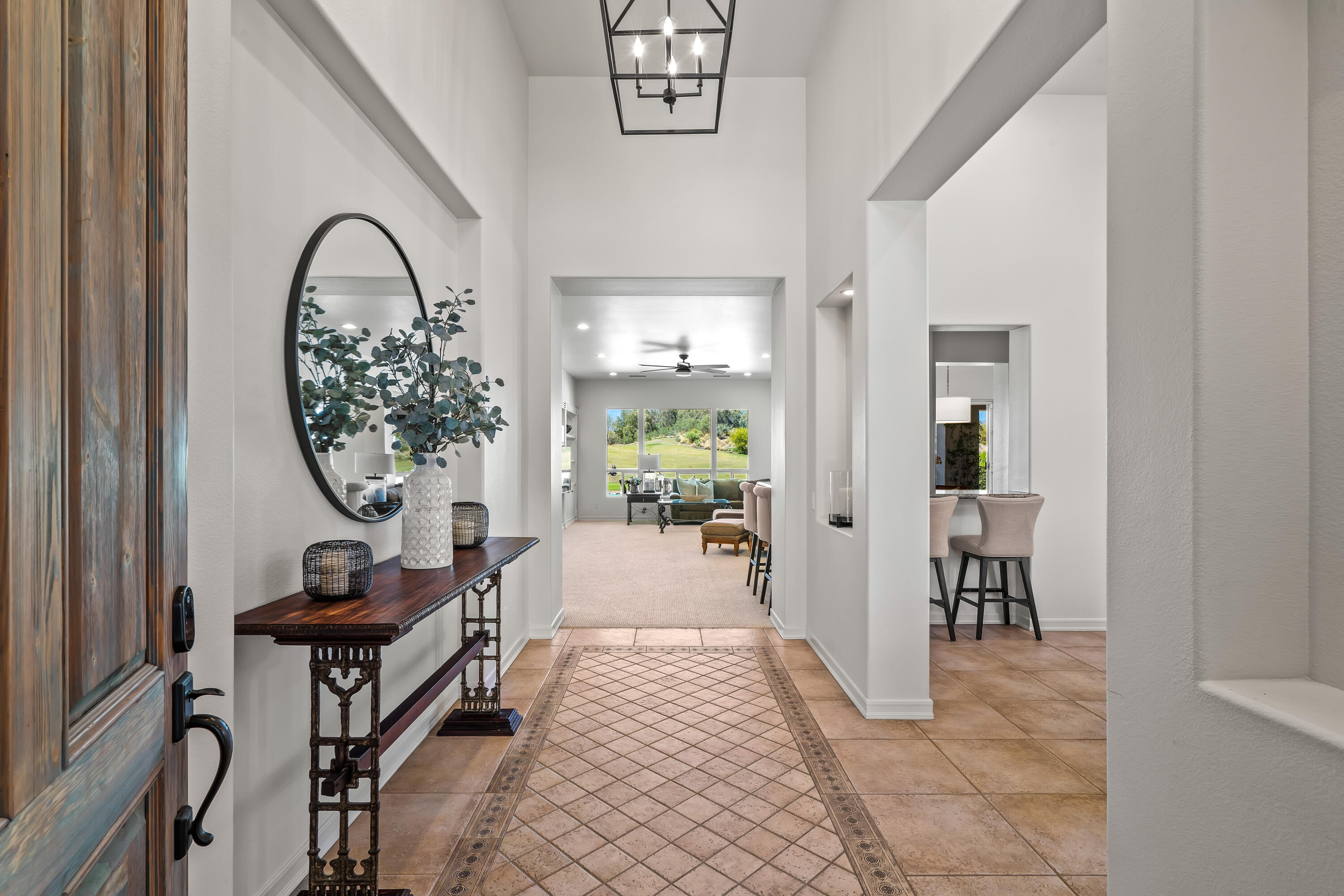 362 Loch Lomond Road Rancho Mirage, CA 92270 - Photo 10 of 26 a view of a hallway with wooden floor and a rug