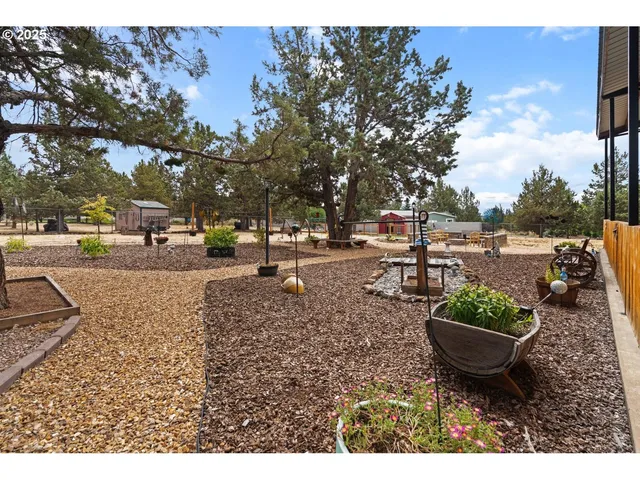 a view of a backyard with sitting area