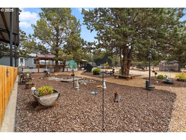 a view of a backyard with table and chairs
