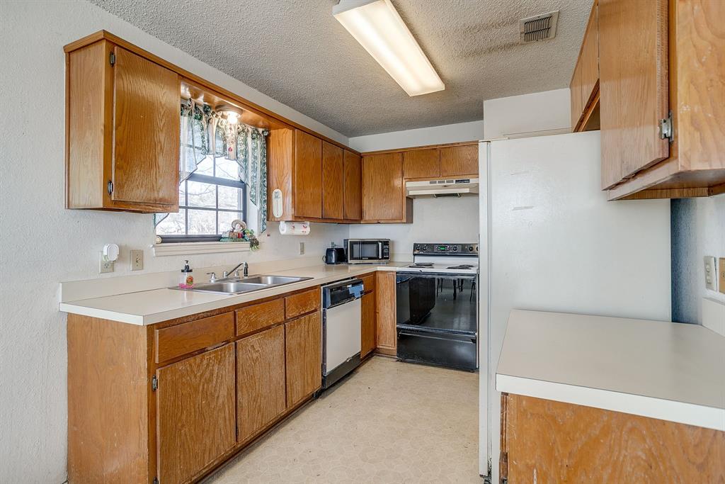3019 Sunrise Trail Weatherford, TX 76088 - Photo 14 of 40 a kitchen with a sink cabinets stainless steel appliances and a window