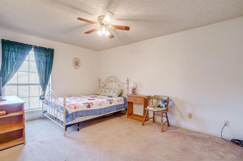 3019 Sunrise Trail Weatherford, TX 76088 - Photo 26 of 40 a bedroom with a bed and a chandelier